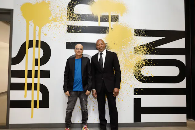 Jimmy Iovine and Dr. Dre standing in front of a wall with the word "disruption"