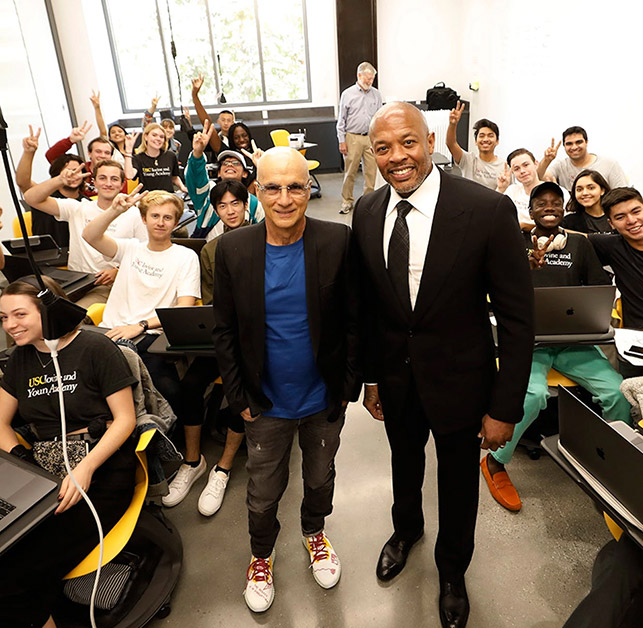 Jimmy Iovine and Dr. Dre standing in front of a classroom of students at the USC Iovine and Young Academy