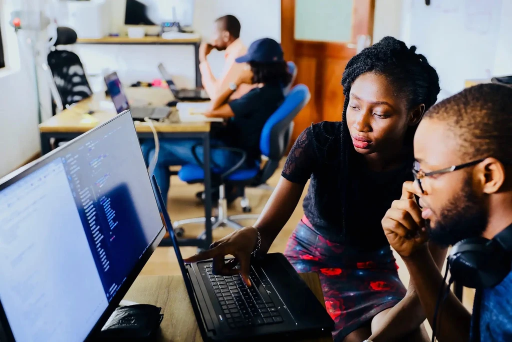 Students working on a computer during a program session