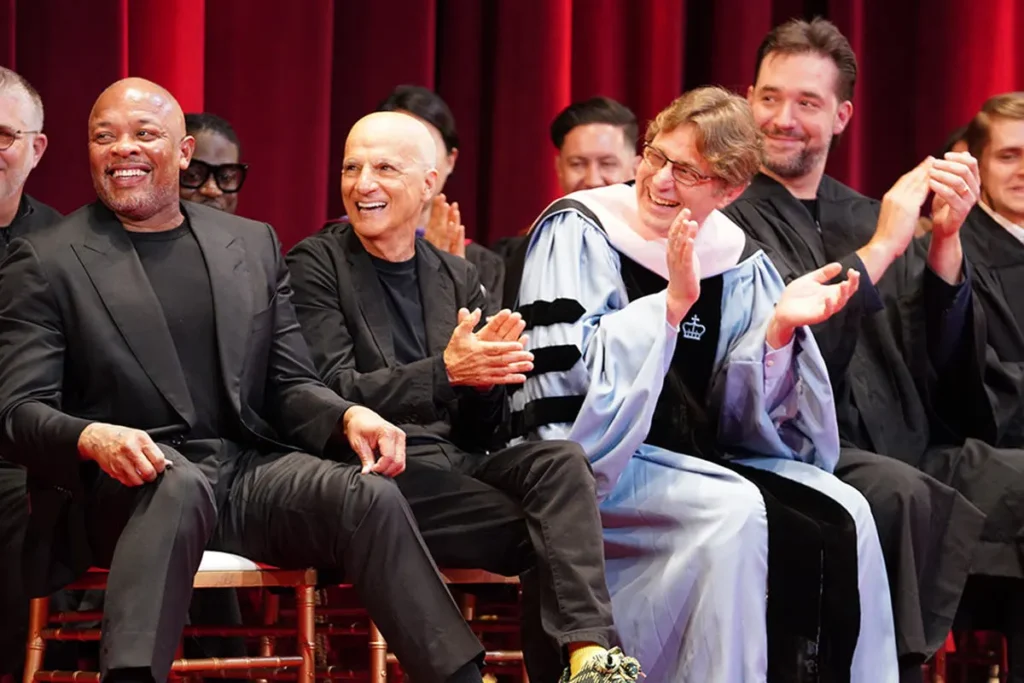 Dr. Dre, Jimmy Iovine, and Iovine and Young Academy faculty clapping and smiling at commencement