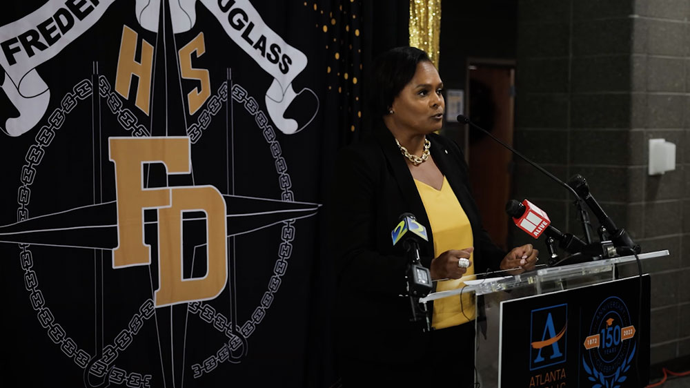 The principal of Frederick Douglass High School in Atlanta stands at a news podium